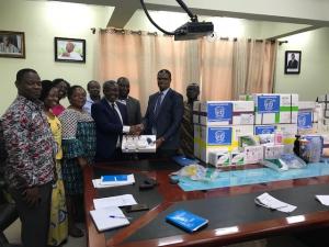Dr Kaluwa presenting items to the Director General of the Ghana Health Service, Dr Anthony Nsiah-Asare
