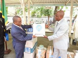 The Permanent Secretary for Health, Dr Mpoki Ulisubisya receiving the items from the WHO Representative, Dr. Adiele Onyeze