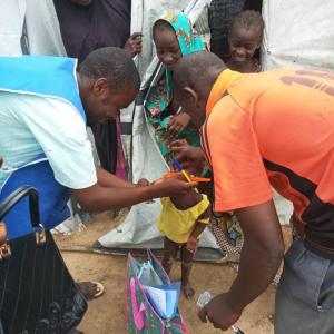 Health worker administering malaria drug to an eligible child during the 3rd  round SMC campaign at El-Miskin camp in Jere LGA.