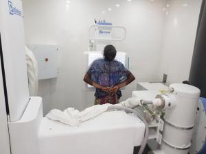 A l'intérieure de la clinique mobile installée au 'Village TB', Place Sainte-Thérèse de N'djili, quartier situé au sud-est de Kinshasa, Une dame passe à la radiographie digitale pour les tests du thorax, à la recherche de la tuberculose - OMS/Eugene Kabambi