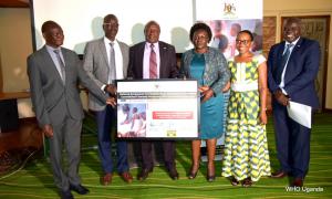 Left-Right: Dr Jackson Oryem, Mr. Ejoru Alphonse, Hon Charles Bakabulindi, Hon Sarah Opendi, Dr Annet Kisakye and Dr Jackson Driwale display the commitment board signed to improve HPV coverage in Uganda