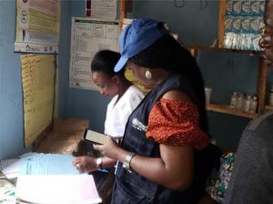 WHO’s Ima Okon and Nurse Sesefu Ayenajeh reviewing the routine immunization register at Aso Pada PHC, Nassarawa State_0.jpg
