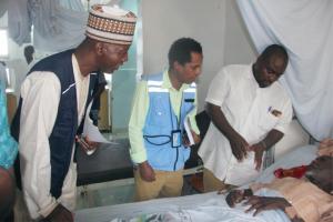 (L-R) Dr Hassan Bala (WHO), Hanibal Abiy OCHA/NHF focal person (and the Chief Nursing officer visiting a  beneficiary of the WHO/NHF fund at the Borno  State Specialist Hospital