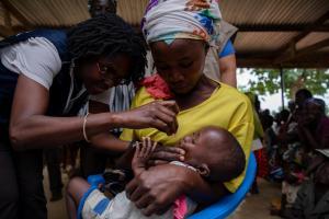 Dr Sally Ann Ohene, Disease Prevention and Control Officer in WCO dosing a child in Ando Nymadou, a community in Chereponi District