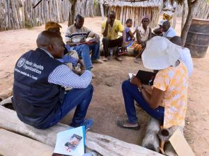 WHO staff in the community listening to local population