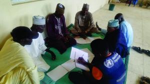 WHO supports health ambassadors in updating their registers after an immunization session at BHC Danfusan, Kiyawa LGA, Jigawa State