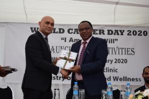 Minister of Health and Wellness, Dr Hon. K. K. S. Jagutpal handing over a copy of the National Cancer Registry Report 2018 to Dr L. Musango, WHO Representative in Mauritius