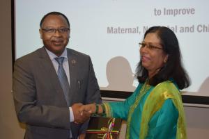 Dr Laurent Musango, WHO Representative in Mauritius receiving a copy of the National Roadmap Framework To improve Maternal, Newborn and Child Health from Mrs. Shabina Lotun, Permanent Secretary of the Ministry of Health and Wellness