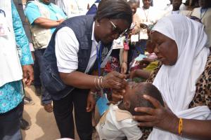 Dr Alimata J. DIARRA-NAMA, Représentant de l’OMS au Burkina Faso, administre des gouttes de vaccin à un enfant