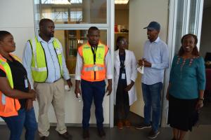 The Minister (2nd from right) and WR (far right) discussing with Port Health Officers and Airport Staff