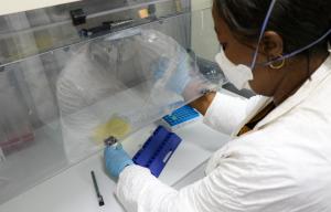 Dr Edith NKWEMBE, Microbiologist of INRB DRC using laboratory reagents to identify COVID-19