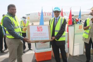 WHO Rep. Dr. Desta Tiruneh handing over donated medical supplies to Hon. Dr. Ahmadou Samateh