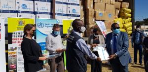 The WHO Representative, Dr.  Nathan Bakyaita handing over the donated items to the Permanent Secretary at the Ministry of Health, Dr. Kennedy Malama (right)  