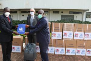 Dr Olushayo Olu, WHO Representative handing over the donation certificate to Dr Mayen Machut Achiek, Undersecretary, Ministry of Health in the presence of Chris Trott, British Ambassador