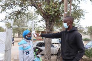 Mmoloki Malemane (right) checking a patient’s temperature before they enter the hospital as part of his Covid-19 pre-screening routine.