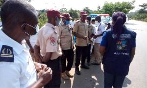 WHO and Ogun State Port Health Service staff address officers of the Federal Road Safety Corps on COVID-19 safety measures at the Idiroko border area in Ogun State. They also hand out protective materials including sanitisers and face masks/ WHO Nigeria