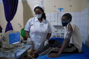 1A nurse performing checks on a diabetic patient in Abuja