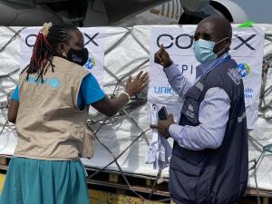   A UNICEF and WHO official receiving the initial batch of COVID-19 vaccines at Entebbe International Airport in Uganda A UNICEF and WHO official receiving the initial batch of COVID-19 vaccines at Entebbe International Airport in Uganda
