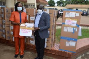 Dr. Wilhelmina Jallah, Health Minister receiving donated items from Dr. Peter Clement, WHO Country Representative