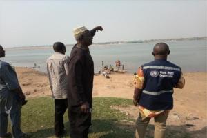 Abinsi Community leader, Garba Yakubu showing WHO SCai,(Benue State) the river where thy get their drinking water.