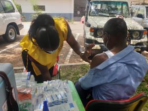 Health worker vaccinating a client in the Kumasi in the Ashanti Region of Ghana