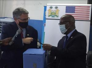L-R: The US Ambassador to Sierra Leone and the Minister of Health and Sanitation at the official handing over of the J&J COVID-19 vaccines donated by the US Government to Sierra Leone
