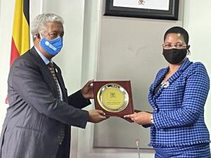 The WHO Representative, Dr. Yonas Tegegn Woldemariam receives a plaque from The Deputy Speaker of Parliament, Rt.Hon. Anita Among in recognition WHO's support to the Government of Uganda in Health