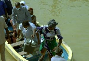 Health workers returning from a riverine settlement.