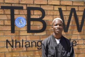 Siphephelosethu Ntjangase poses outside Nhlangano health center where he is receiving treatment