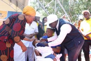 WR a.i. Dr. Zabulon Yoti giving polio drops to a child at the launch event