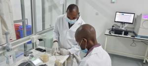 National Microbiology Reference Laboratory Scientists processing Tricycle samples on Vitek 2 machine