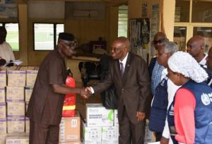 The WHO Country Representative, Dr Mulombo handing over donated items to Ondo state Commissioner for health Dr Ajaka.jpg