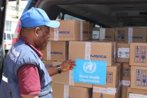 WHO staff member inspecting the medical supplies prior to offloading at the Ministry of Health