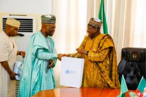 The Governor of Kano (right) receiving WHO Nigeria souvenirs from the WR