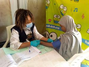 Mrs. Mercy Ameh checking the blood pressure of a pregnant woman in hard-to-reach area