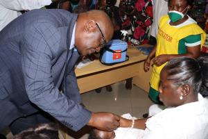 WHO Representative Ghana Dr. Francis Kasolo, administering polio vaccine to a child to kick start the immunization campaign
