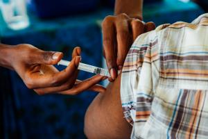 A healthcare provider giving COVID-19 vaccine in Manyara