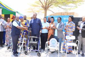 Dr. Yoti handing over assistive products to the Guest of Honor