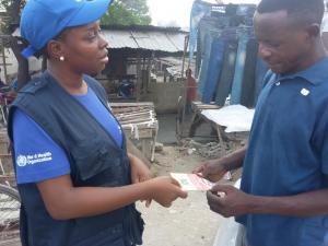 WHO staff interacting with a community member during the supportive supervision mission