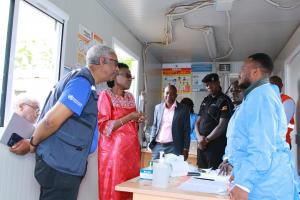 Uganda Health minister Dr. Jane Ruth Aceng (in Red) and WHO Representatitive (First left) Dr. Yonas Tegegn Woldemariam interact with Ministry of Health staff at the screening booth in Mutukula