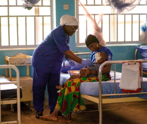  A nurse dressing the sore on the face of a patient suffering from Noma (photo credit Ogbeide