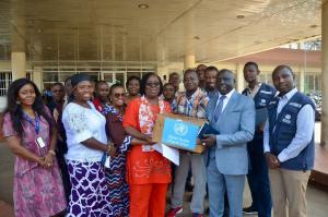 Dr Catherine Cooper, representing the Ministry of Health receiving the donation from WHO Rep, Dr Clement Peter.