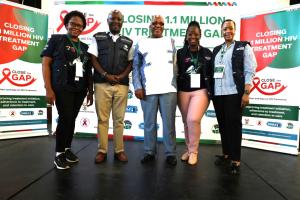 WHO staff with Minister of Health, Dr Aaron Motsoaledi (middle) during the Closing 1.1 Million HIV Treatment Gap Campaign at Chris Hani Baragwanath Hospital in Johannesburg