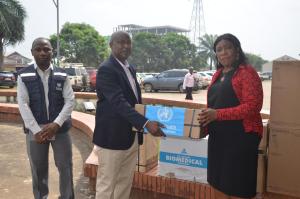  Dr. Cuallau Jabbeh Howe, the Assistant Minister of Health, receiving the donation from WHO OIC, Dr Abdullahi Sule