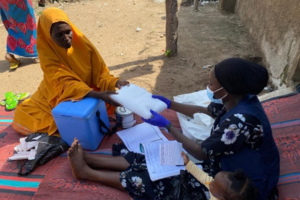 1A WHO volunteer at the field providing health services to women and children at a camp for people displaced by flood in Adamawa State