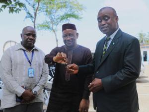 WHO Country Representative handing over motorbike keys to the Deputy Minister of Health