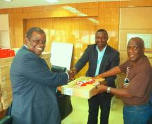  Dr. Musa handing over the donated items to the Liberia    Chief Pharmacist Rev. Tyler (right is the Assistant Minister of Admin. Mr. John Linga)