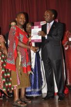 Cabinet Secretary James Macharia hands over the FCTC publication to Mr Vuyile Dlamini of Swaziland to celebrate Africa’s decade implementation of tobacco control