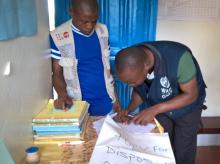 WHO field officer reviewing tOPV retrieval form