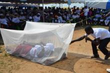 Drama illustrating proper use of a mosquito bed net